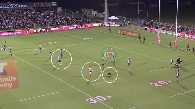 Two Parramatta trainers (circled) are the only trainers on the field seconds before time was called off for Mitch Kenny (circled right).