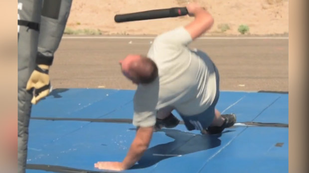 A man falls to ground after being Tasered in a test.