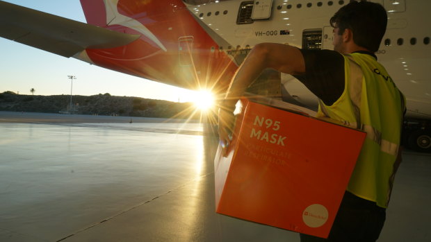 Donated face masks being loaded on to a Qantas plane at Los Angeles airport. The plane arrived in Melbourne on Wednesday ahead of deteriorating weather conditions forecast for Friday.