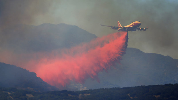 A 747 Global air tanker makes a drop on a wildfire in Scotts Valley on Friday.