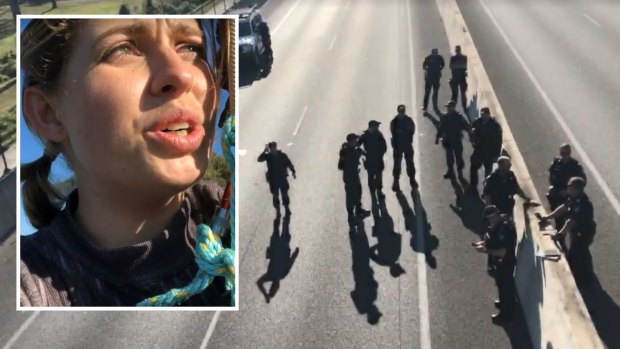 A woman livestreamed to social media from a pole high over the Port of Brisbane Motorway, before police swarmed.