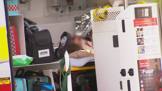 One of the occupants of the car in the Beverly Hills crash inside an ambulance on Friday morning.
