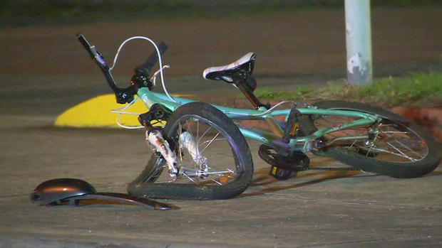 The girl's mangled bike lies on the road after the crash