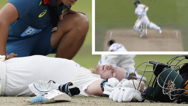 Australia's Steve Smith receives treatment as lies on the ground after being hit on the head by a ball bowled b England's Jofra Archer. 
