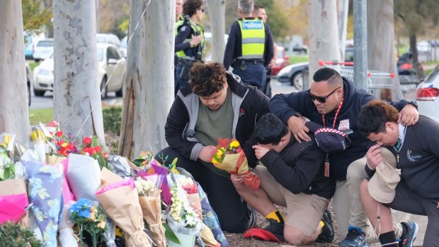 Mourners gather at the site where Solomone Taufeulungaki, 15, was killed in Deer Park on Tuesday afternoon.