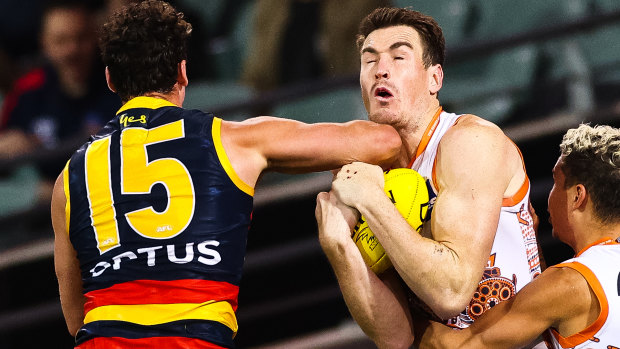 Tough night: Kyle Hartigan of the Crows collects Giants star Jeremy Cameron.