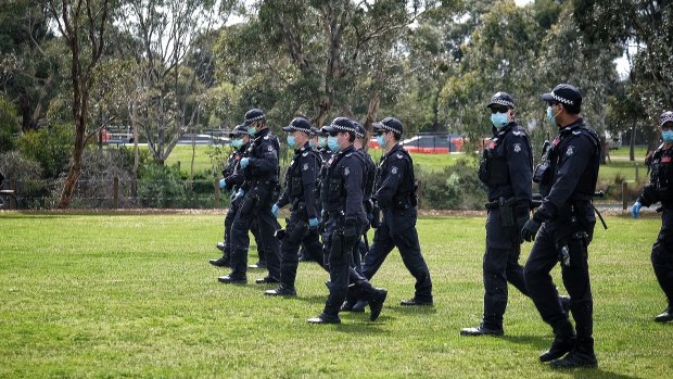 Police march through Elsternwick Park on Saturday
