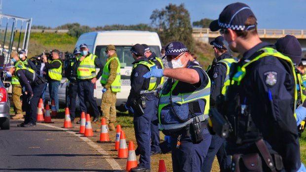 ADF personnel and Victoria Police at a checkpoint on the Princes Freeway on the outskirts of Melbourne.