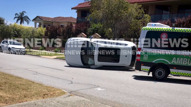 Fremantle forward Jesse Hogan climbed from his car after it flipped after a crash in Bicton on Sunday.