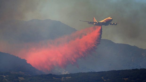 A 747 Global air tanker makes a drop on a wildfire in Scotts Valley on Friday.