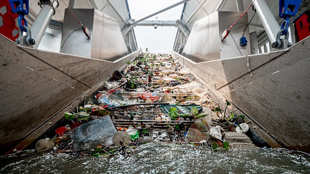 The Ocean Cleanup’s “Interceptor” vessel trawls a river in Malaysia for plastic before it hits the ocean.