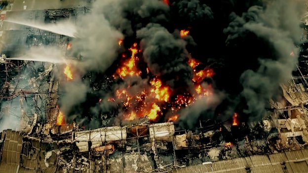 Firefighters on platforms battle the West Footscray factory fire of August 30, 2018. 