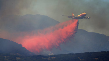 A 747 Global air tanker makes a drop on a wildfire in Scotts Valley on Friday.