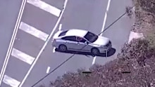 A PolAir helicopter tracking a stolen silver sedan was in the line of fire when a young man on the run is accused of firing a shot at the aircraft.