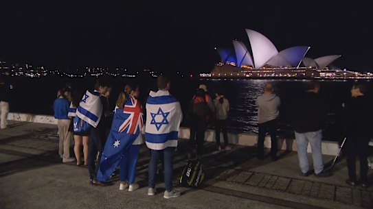 Warned off by police from attending the Sydney Opera House, supporters of Israel watched from afar on Monday night as it was lit up in blue and white. Pro-Palestinian protesters, meanwhile, filled the Opera House forecourt.