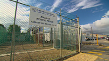 An inmate has escaped from Adelaide Pre-Release Centre allegedly returned with bottles of alcohol, raising questions over safety and security at the facility.