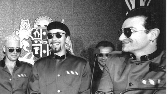 U2 meets then NSW Premier John Fahey in Sydney and presents him with a new pair of sunglasses.