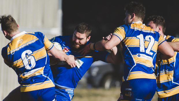 Rams Sean Maloney and Michael Gilmour stop West Belconnen's Fraser Harvey in his tracks.