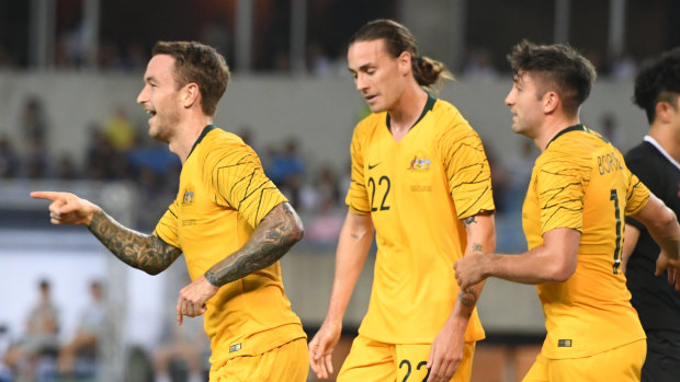 Adam Taggart (left) has managed to restart his Socceroos career.