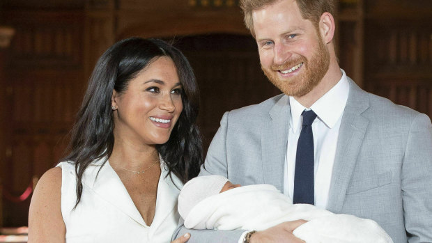 Harry and Meghan, the Duke and Duchess of Sussex, with their newborn son in St George's Hall at Windsor Castle in May.