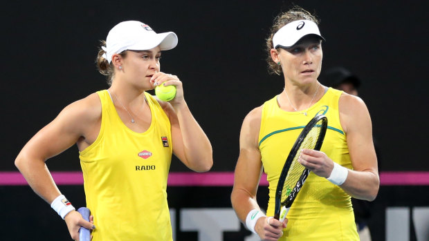 Game plan: Australia's Ashleigh Barty and Samantha Stosur talk tactics during the deciding doubles rubber against France.