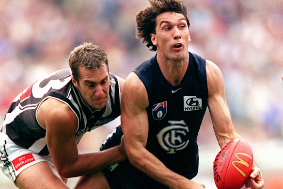 Stephen Silvagni in action against Collingwood and Anthony Rocca at the MCG.