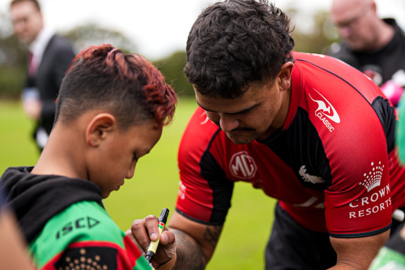 Latrell Mitchell takes time out with a young Perth-based fan.