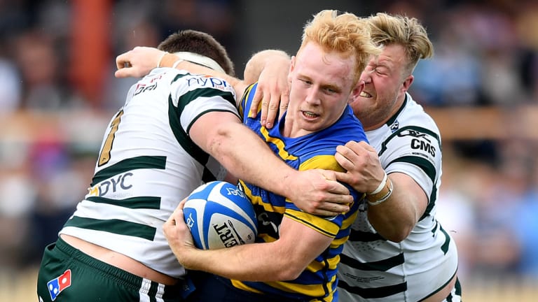Rookie of the year: Sydney University's Will McDonnell is tackled in the Shute Shield grand final.