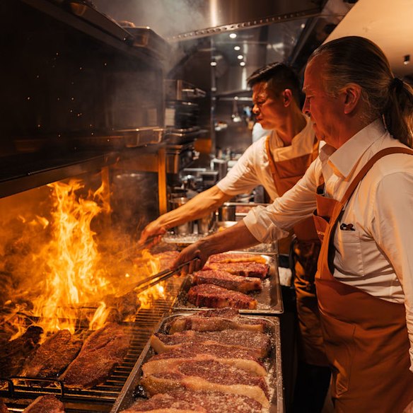 Chef Neil Perry grilling steaks at Margaret.