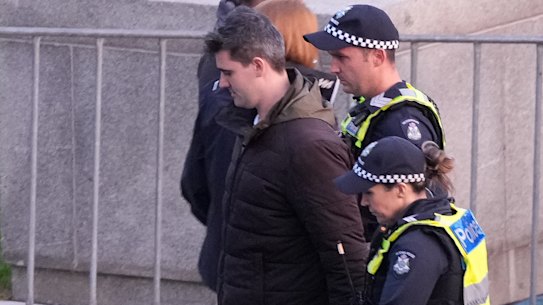 Police lead away white supremacist Jacob Hersant, who heckled the Welcome to Country at the dawn service at Melbourne’s Shrine of Rememberance.