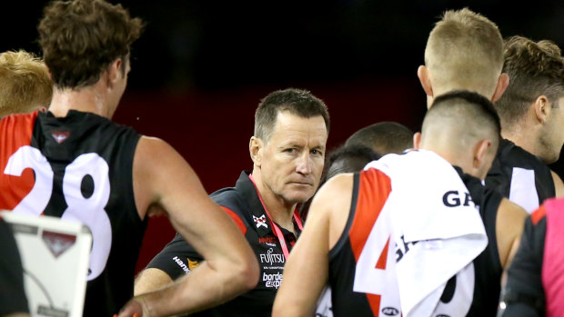 Off message: Bombers coach John Worsfold with his players at three-quarter time during the round 2 clash against the Saints.