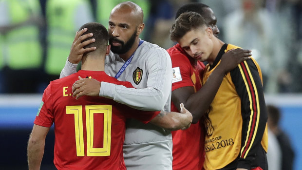 Tough loss: Eden Hazard is comforted by assistant coach Thierry Henry.