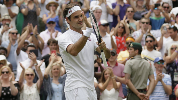 Marching on: Roger Federer applauds the crowd after his win.