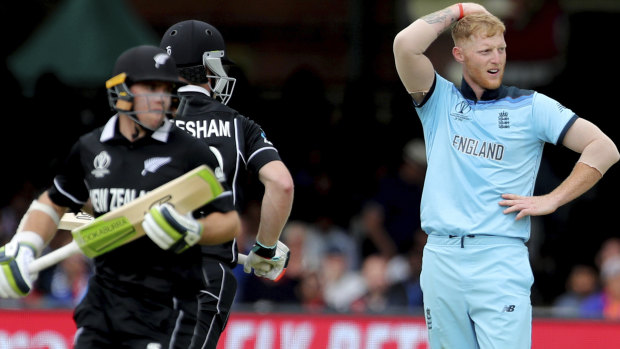 England's Ben Stokes, right, reacts after a boundary hit by New Zealand's James Neesham, centre, during the Cricket World Cup final.