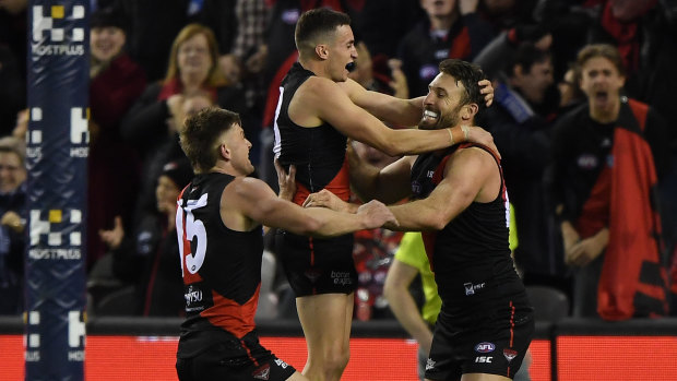 Off the canvas: Bombers Jayden Laverde, Orazio Fantasia and Cale Hooker celebrate after leaving the Giants stunned.