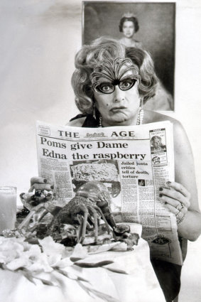 Dame Edna Everage reading The Age newspaper with headline ‘Poms give Dame Edna the raspberry’ in 1981.