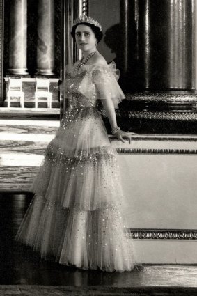 The Queen Mother photographed by Cecil Beaton in a Norman Hartnell gown in the Music Room of Buckingham Palace in 1939.