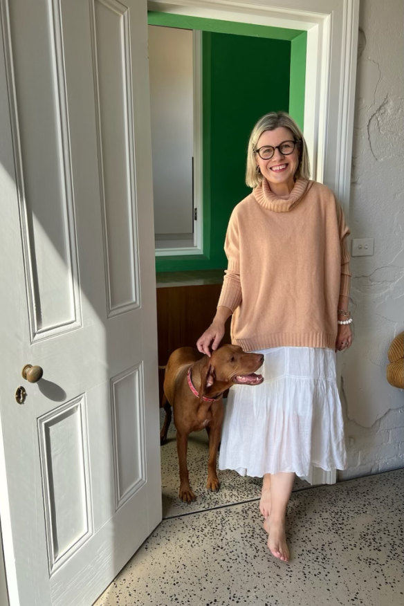 Sally, one of the manor’s owners, with Ruby, her vizsla. “The clients didn’t want anything too clean, too neat,” architect Moloney says. “If the afternoon light raked across a wall, they wanted to see the imperfections in it.”