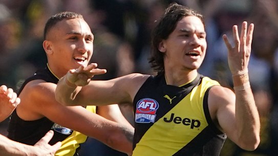 Daniel Rioli (right) signals 44 in honour of his cousin Willie, who has been provisionally suspended.