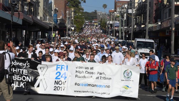 Thousands of people make their way down Coogee Bay Road as part of Sydney's annual White Ribbon walk in 2017.