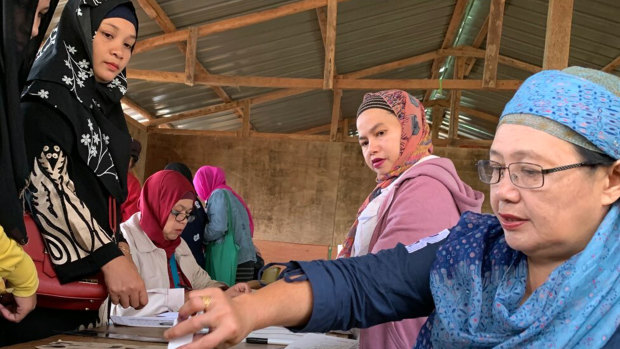 A Muslim woman casts her ballot in a referendum at the Marawi Sagonsongan elementary school-turned polling station in Marawi.