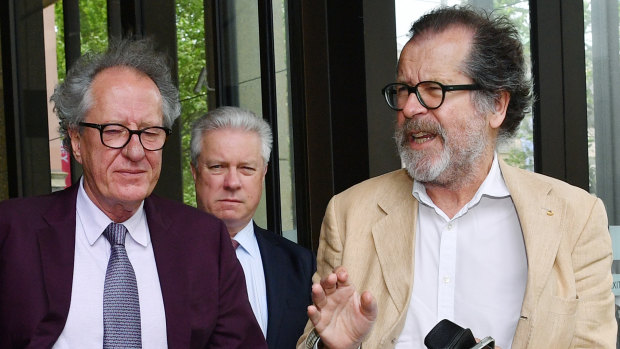 Geoffrey Rush with theatre director Neil Armfield, right, outside the Federal Court on Wednesday. 