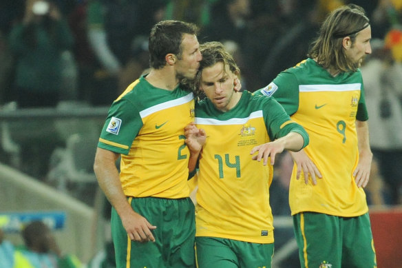 Lucas Neill shows his appreciation for Brett Holman after his goal put Australia 2-0 up.