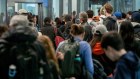 Travellers wait to go through security at San Francisco International Airport.