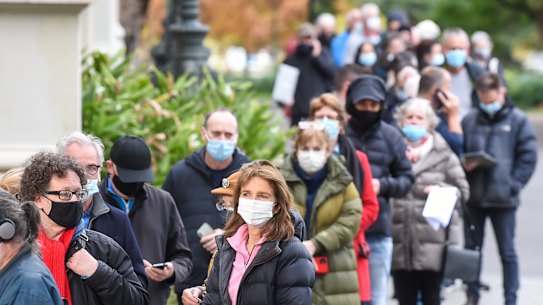 People queue to receive their COVID-19 vaccinations at Melbourne’s Royal Exhibition Building.