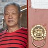 Ma Peizeng (right), 73, and his wife Wu Xiuhua, 73, at the door that opens into their shared courtyard residence in Dafangjia Hutong in east Beijing’s Dongcheng district.