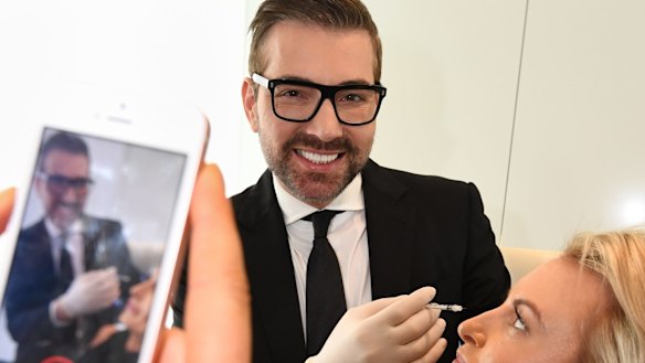 Rival surgeon Dr Kourosh Tavakoli, Sydney's 'King of Boobs', with a staff member. 