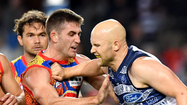 Gary Ablett scuffles with Gold Coast's Anthony Miles.