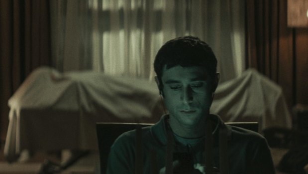 Yakov (Dave Davis) sits in front of the body of Mr Litvak in horror film The Vigil. 