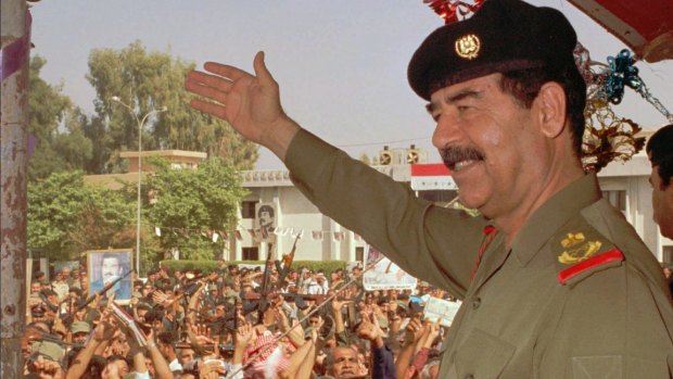 Then Iraqi president Saddam Hussein waves to supporters in Baghdad in 1995.
